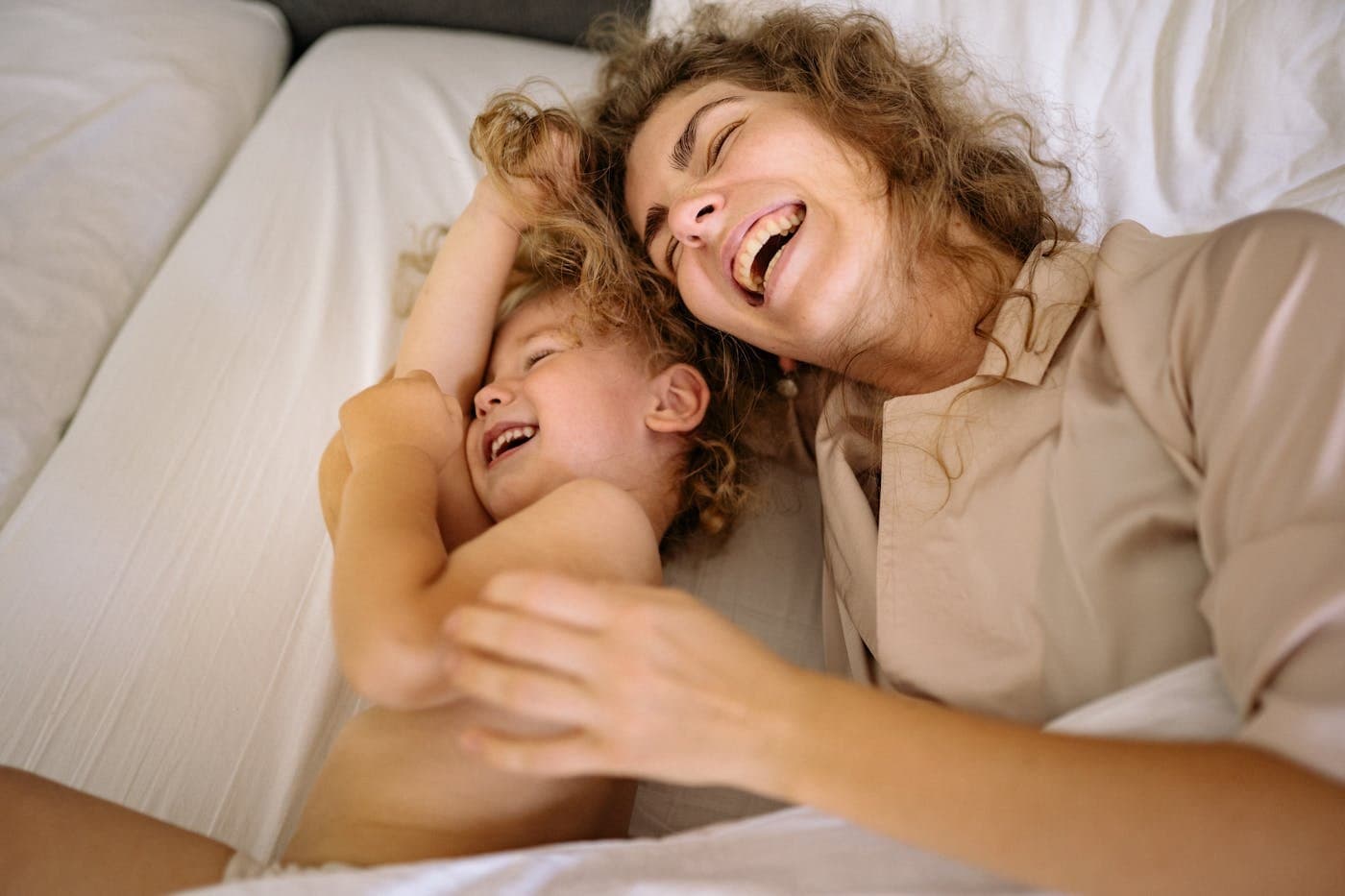 Mother and toddler sharing a peaceful, joyful moment together in bed