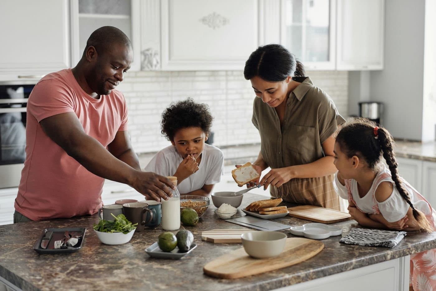 Family preparing breakfast together in a modern kitchen