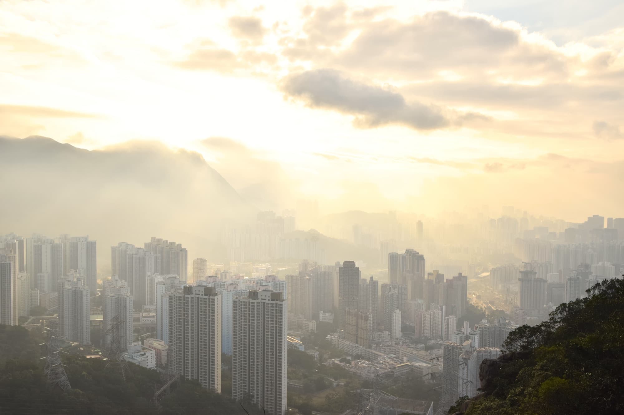 Golden light over Kowloon towers, seen from a ridge on Lion Rock in Hong Kong